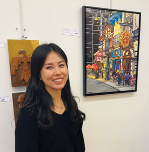 Juyeoun Kim with her Market Square painting.