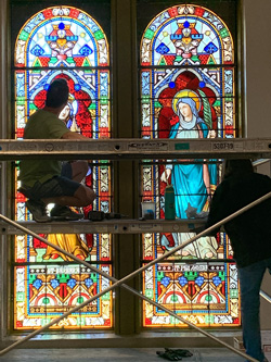 Reinstallation of St. Barbara and St. Philomena windows.
